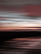 Load image into Gallery viewer, Long exposure panning photograph from the beach during sunset in Scheveningen. The sky is has pastel colours.
