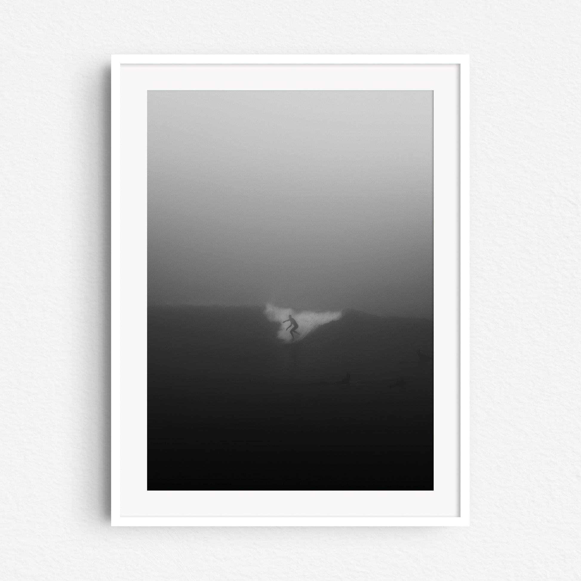 Foggy and minimalistic black and white surf art from the Hague, framed in white wood.