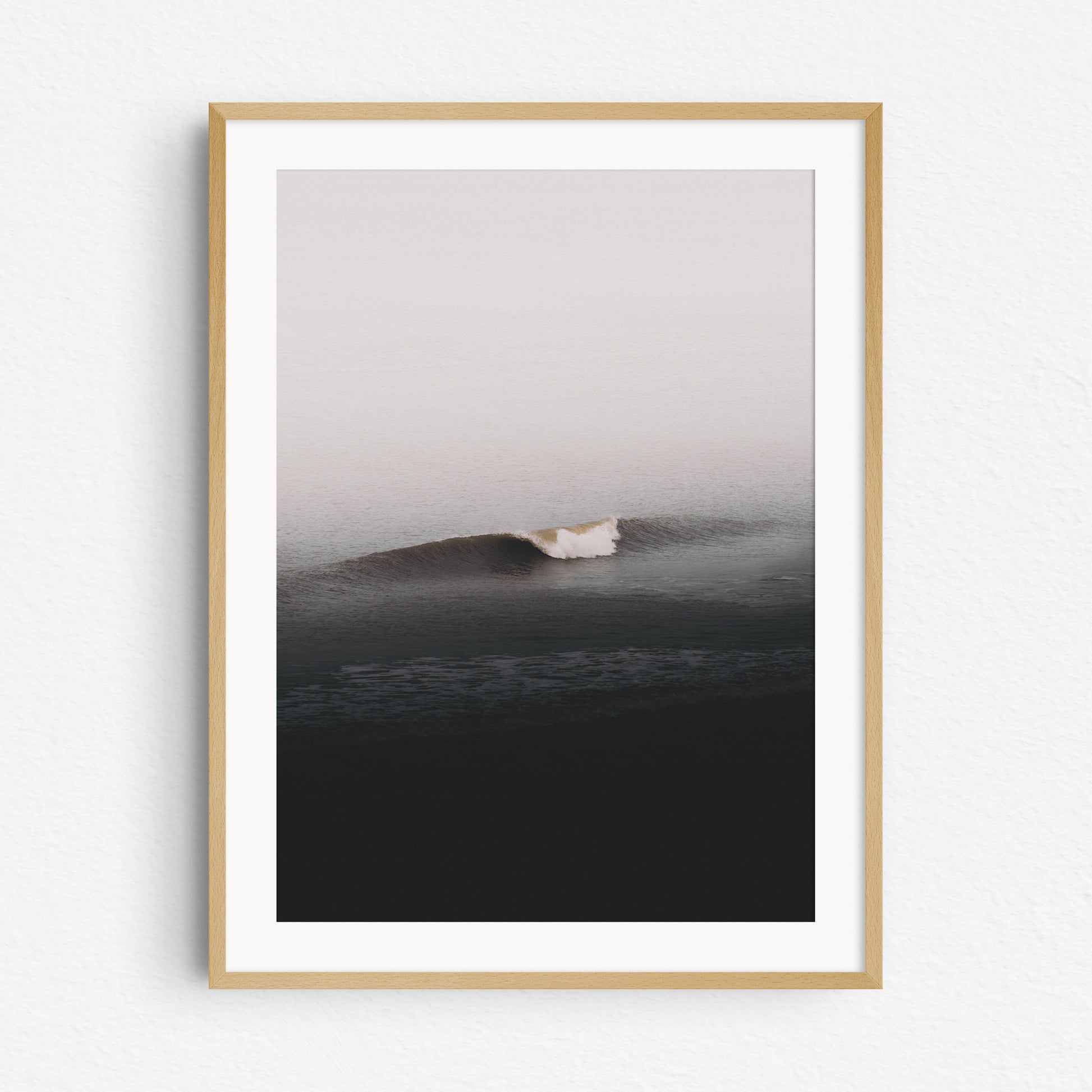 A clean North Sea wave in a natural wooden frame, captured by Jop Hermans.