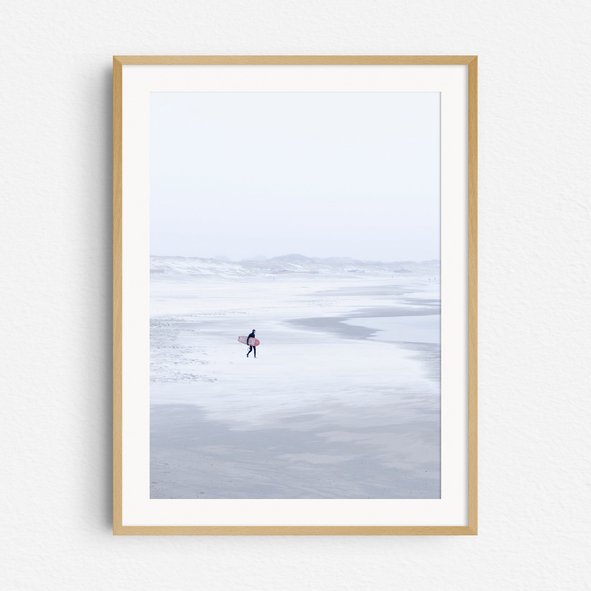 Winter surf photography in The Netherlands. A photo print in a natural wooden frame.