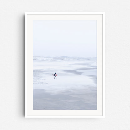 Photo print of a winter scene on the Scheveningen beach in a white wooden frame.