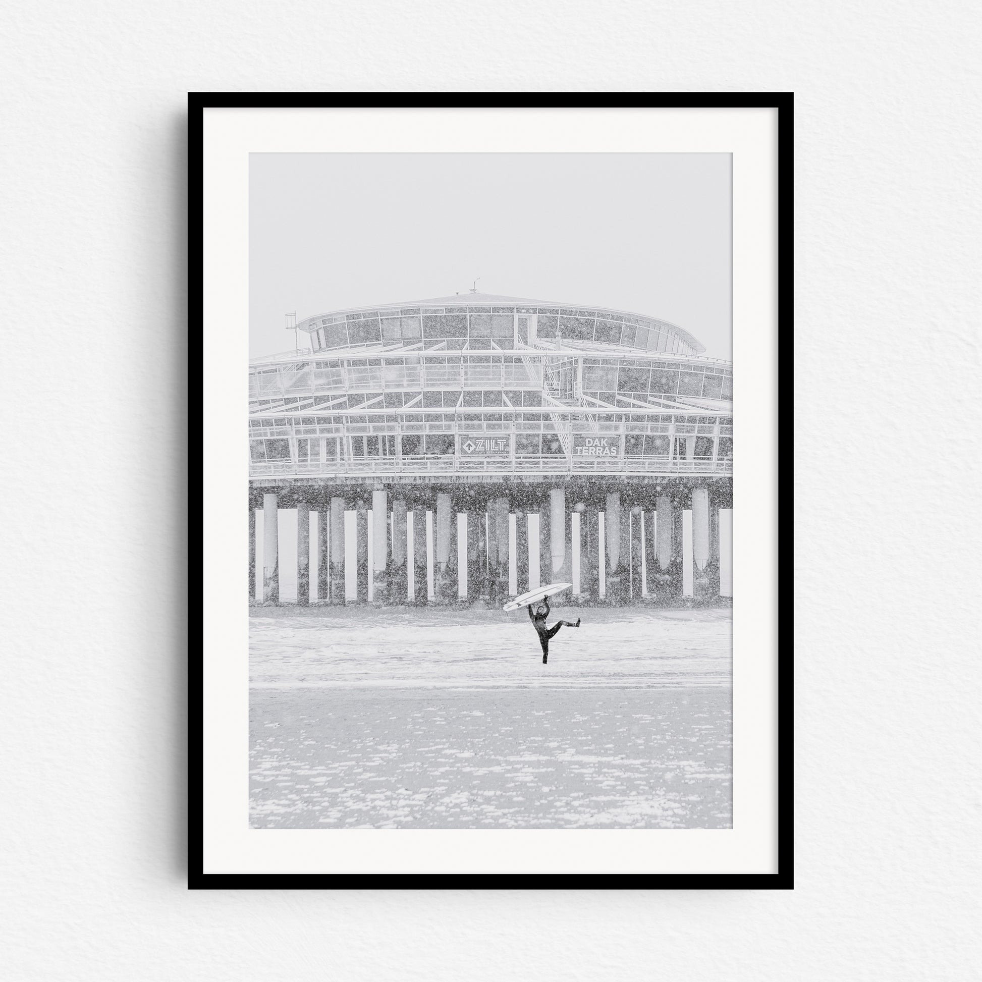 Winter surfing in The Netherlands is great! High quality photo print in a black wooden frame.