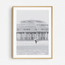 Load image into Gallery viewer, A local The Hague surfer is happy during a surf session in a snow storm, framed in a natural wooden frame.
