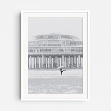 Load image into Gallery viewer, White wooden frame with a surf photo of a happy surfer in a snwostorm.
