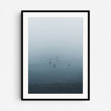 Load image into Gallery viewer, A photo of surfers in Scheveningen in thick fog. Photo print in a black wooden frame.
