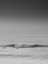 Load image into Gallery viewer, Two surfers paddle towards a broken wave in the North Sea, captured by Jop Hermans.
