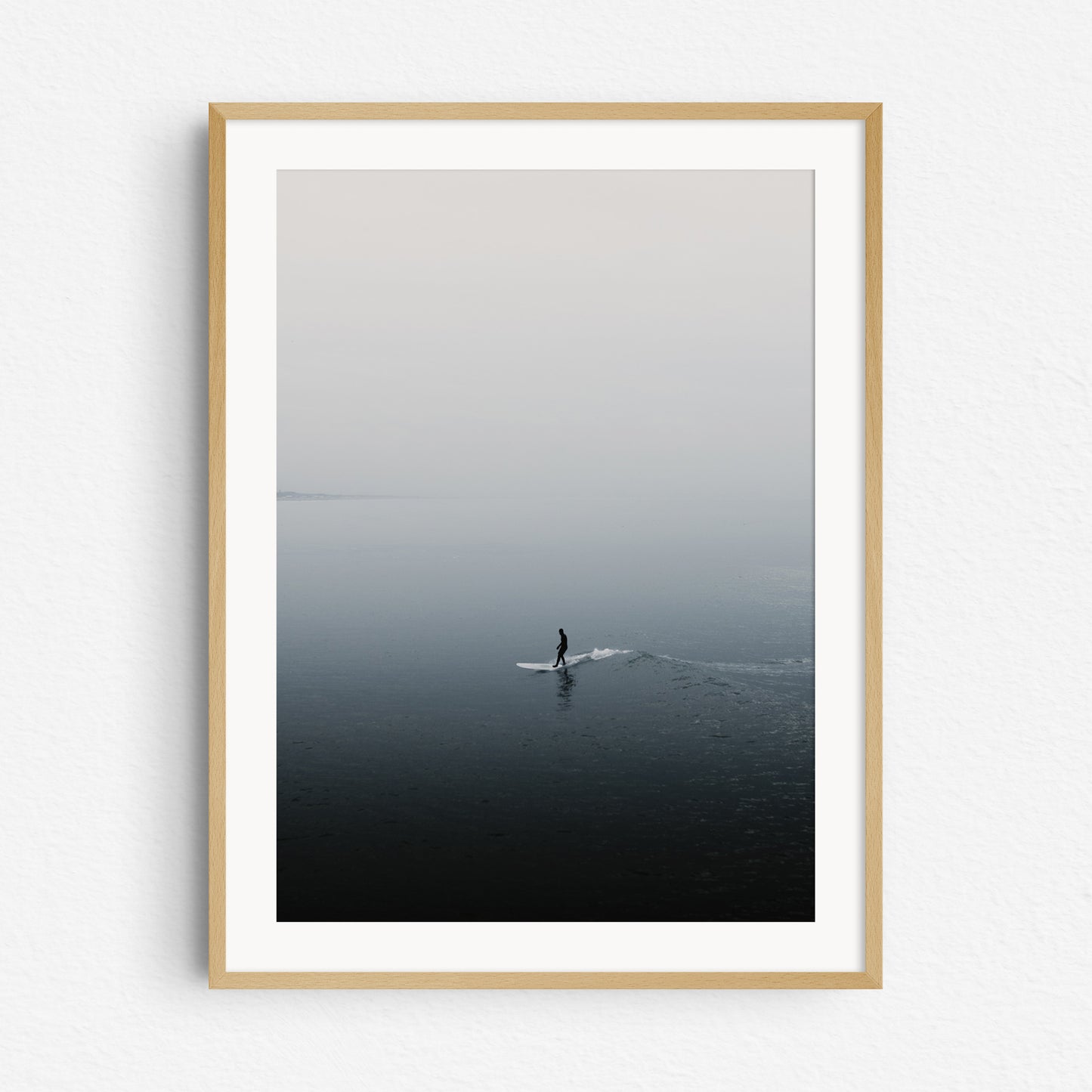 The shade of a surfer reflects on the North Sea surface, framed in natural wood, ideal for surf photography and nature photography fans. Artwork created by Jop Hermans