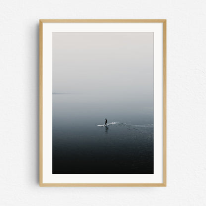 The shade of a surfer reflects on the North Sea surface, framed in natural wood, ideal for surf photography and nature photography fans. Artwork created by Jop Hermans