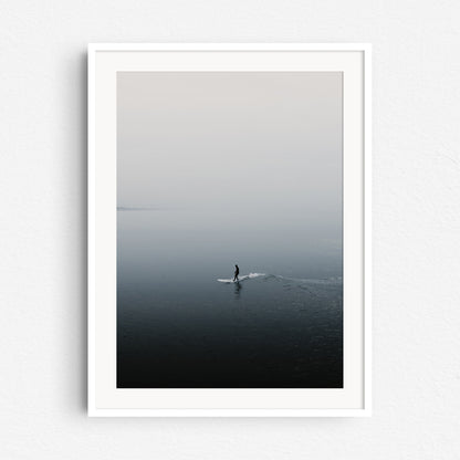 The calming silhouette of a surfer in the North Sea, framed in white wood, a peaceful addition for North Sea Surf Photos lovers.