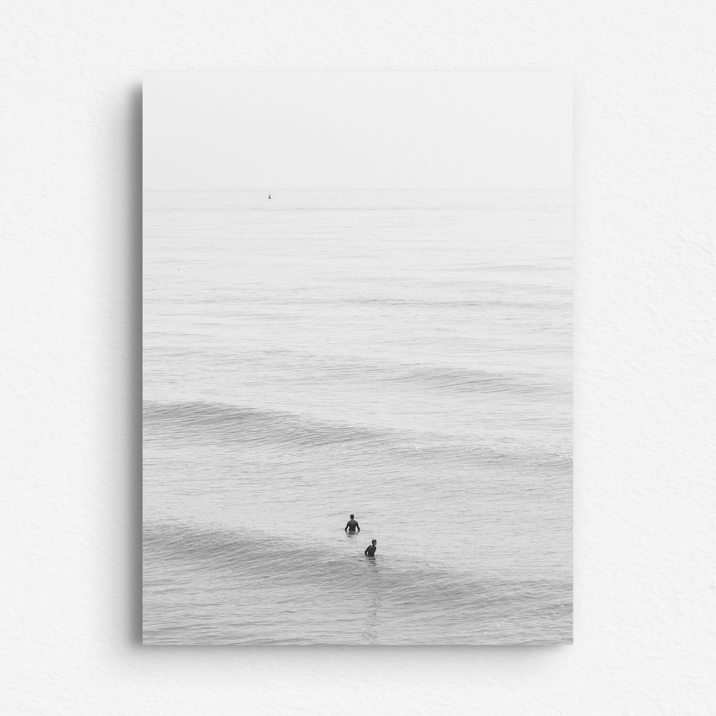 Dibond photo print of surfers in the dutch North Sea, captured by Jop Hermans.