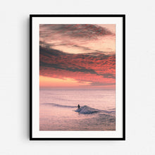 Load image into Gallery viewer, A serene Dutch sunset photo with warm orange hues and a lone surfer. Framed in black wood for bold, contemporary wall art.
