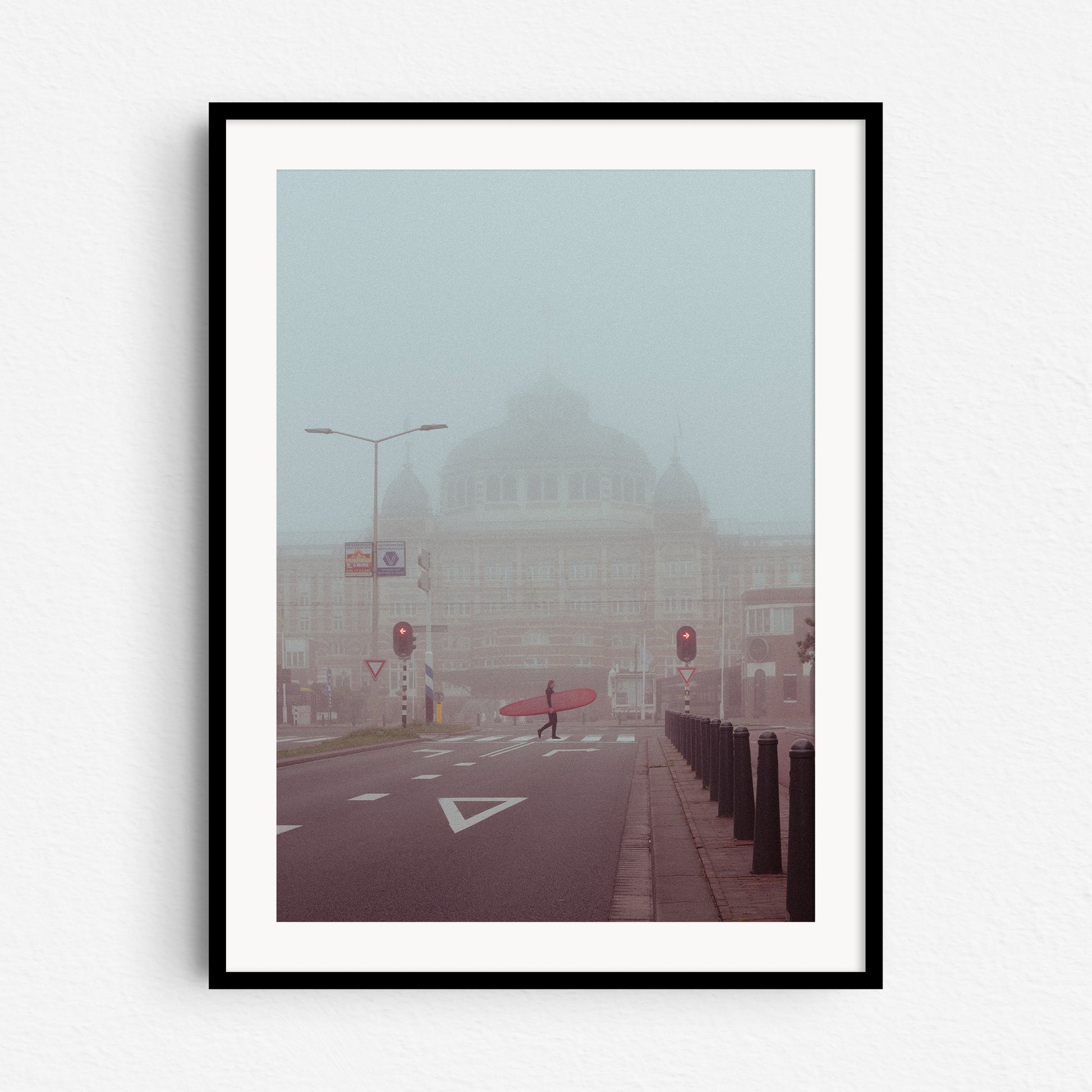 Surfer in the mist in a Dutch surf scene, captured by Jop Hermans. Photo in a black wooden frame.