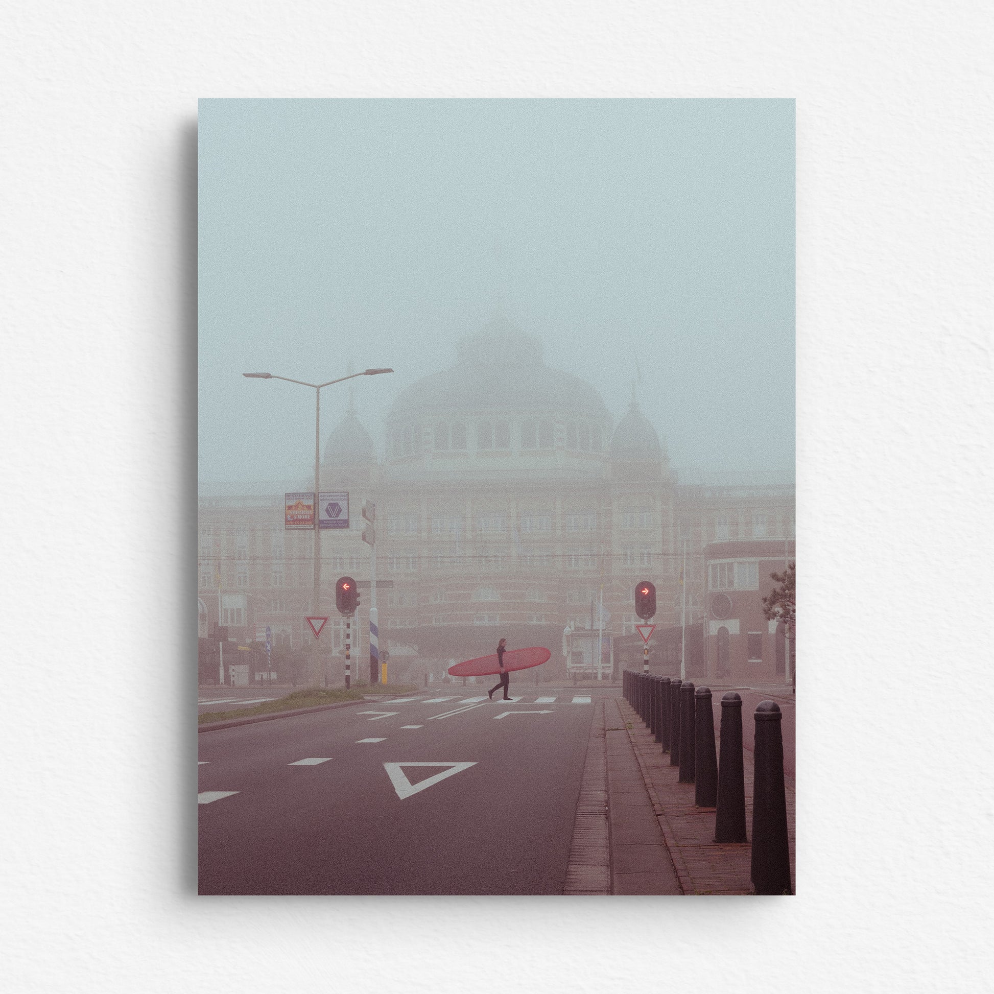 Surfer in front of the Kurhaus Hotel in The Hague, walking in the mist. Printed on dibond.