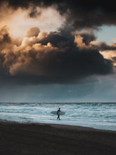 Load image into Gallery viewer, Valhalla is the photo of a surfer in Scheveningen during the moody season. Heavy clouds and a wild sea
