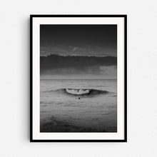 Load image into Gallery viewer, A surfer watches a wave break in front of him. A black and white surf print in a black wooden frame.
