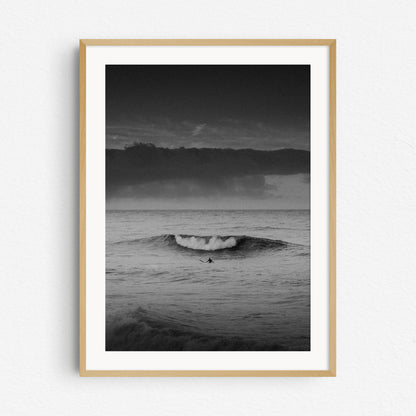 Black and white surf photography in a natural wooden frame.