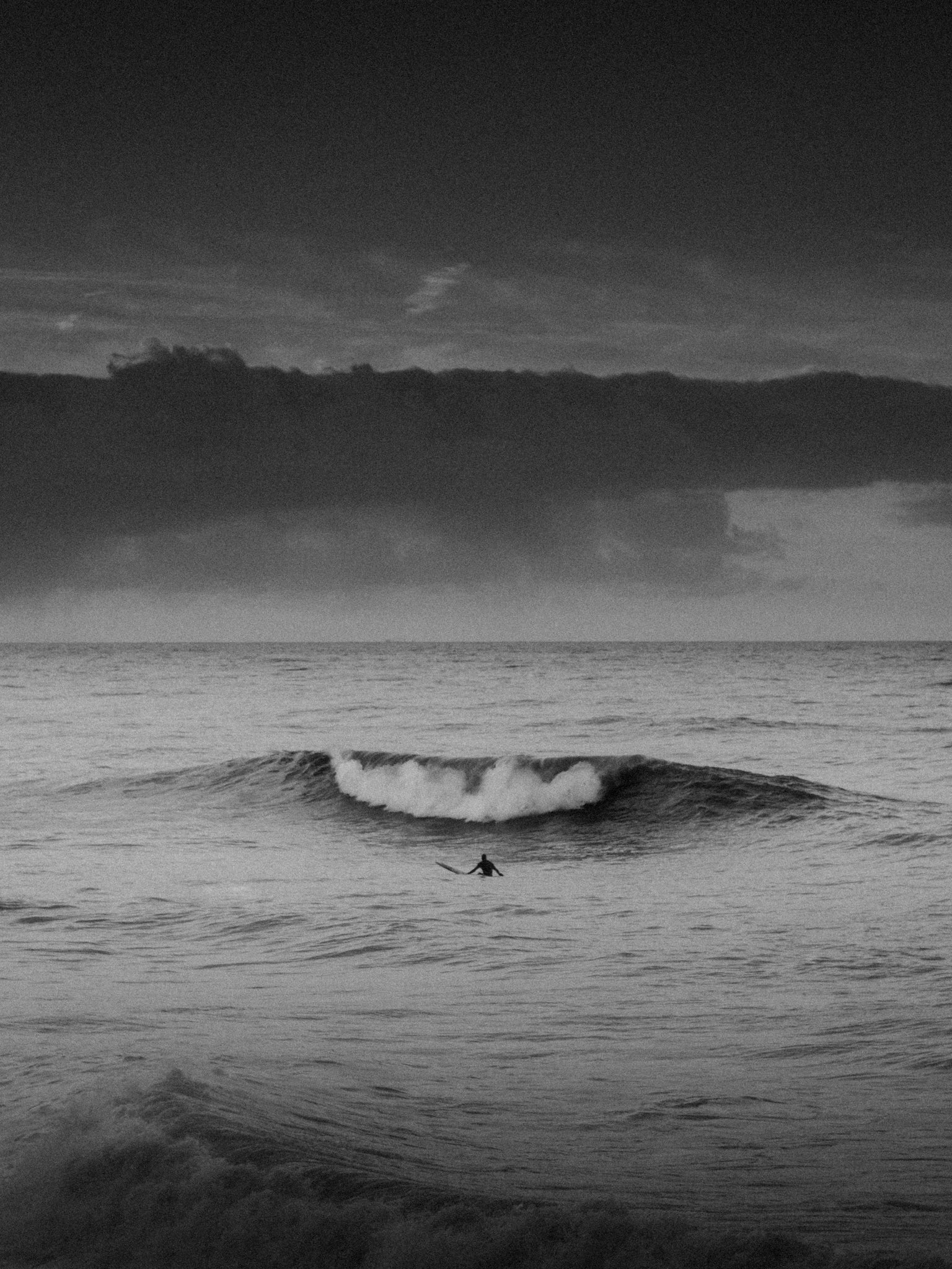 North Sea black and white surf shot of a surfer in the sea, captured by Jop Hermans.