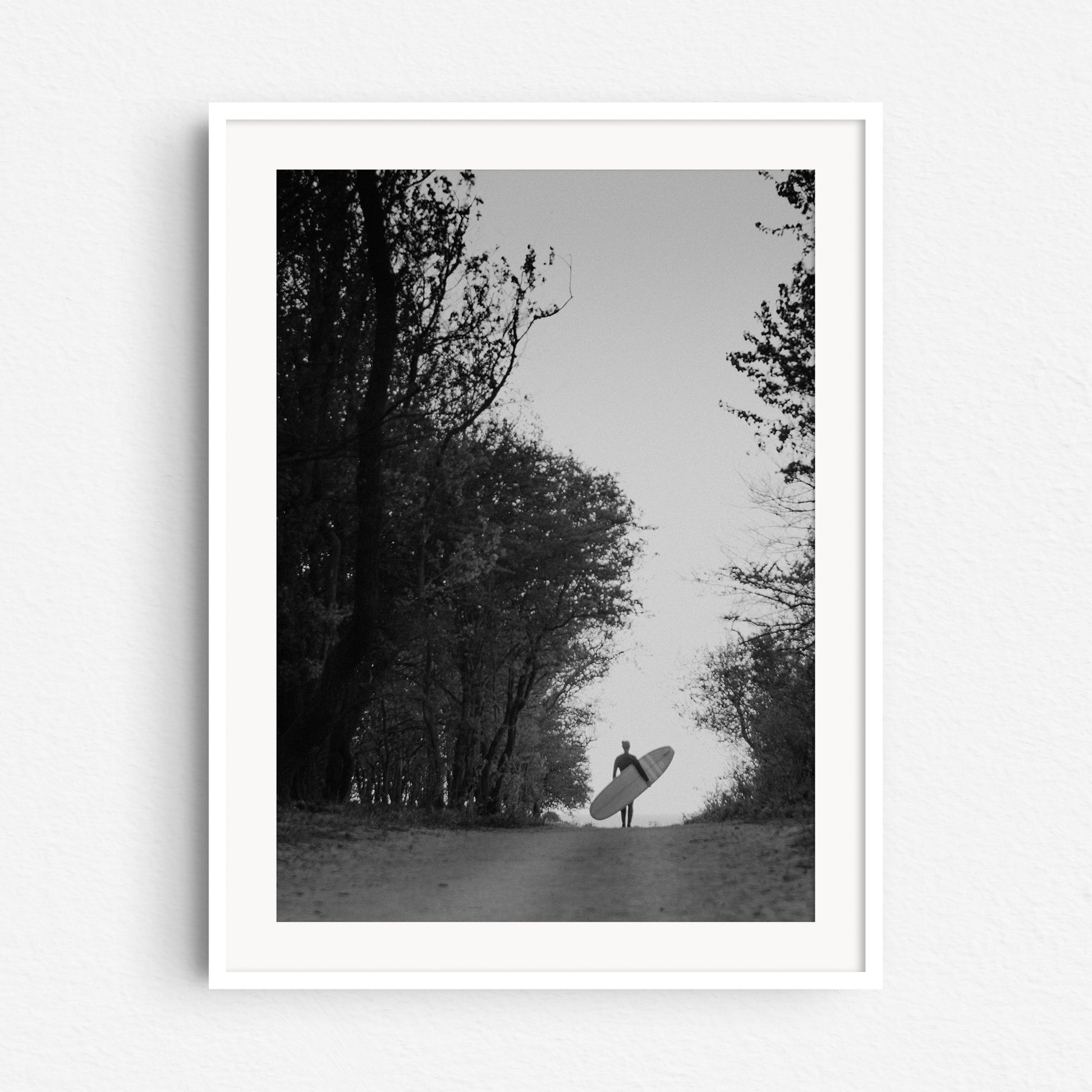 Black and white retro surf photo print in a white wooden frame, shot in The Hague.