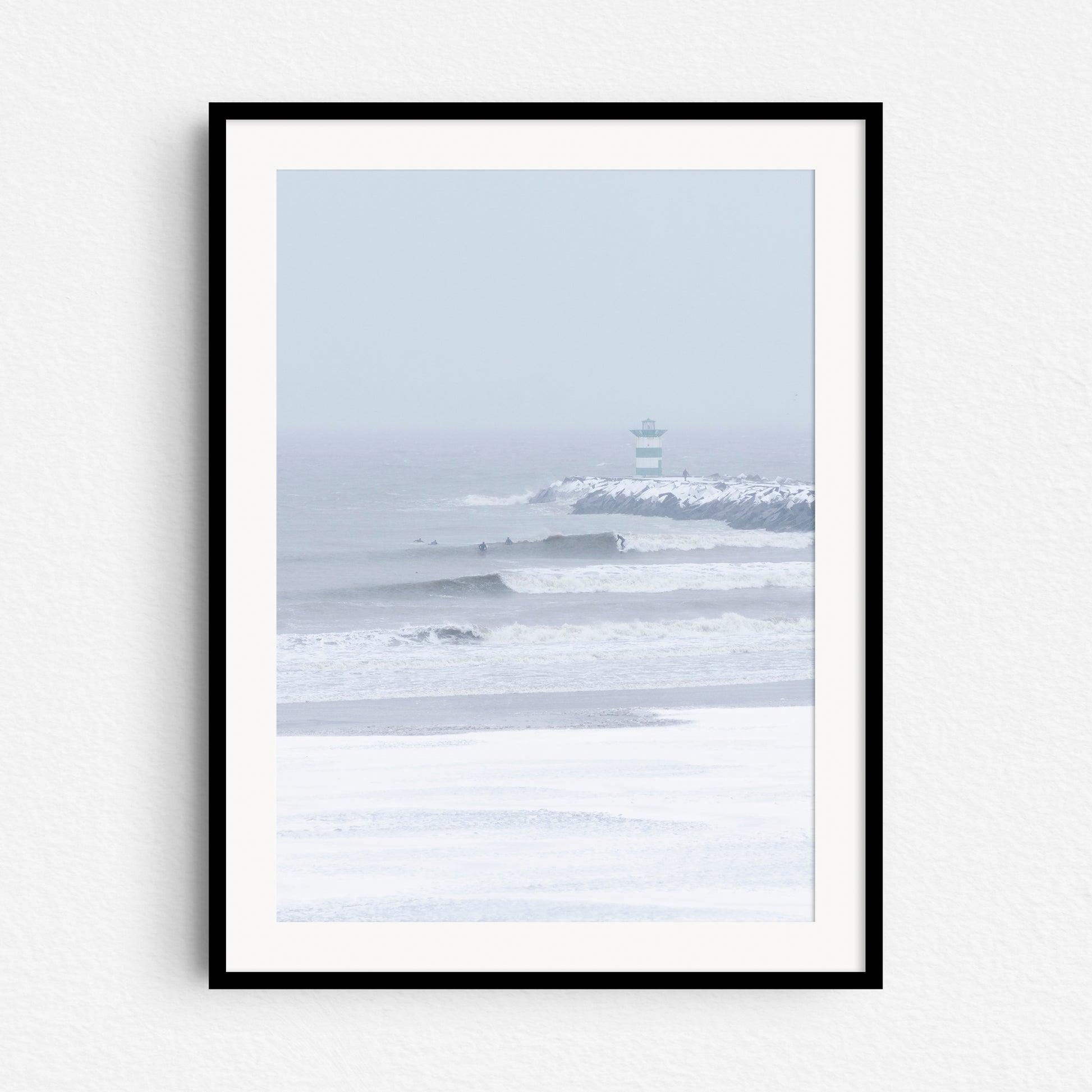 Winter surfing in Scheveningen framed in black wood, captured by Jop Hermans.