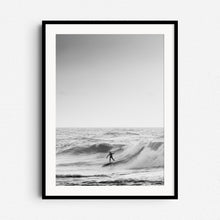 Load image into Gallery viewer, Black and white photo of a surfer riding a wave in the North Sea, framed in black wood, perfect as large wall decoration for photo art lovers.
