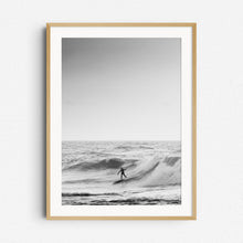 Load image into Gallery viewer, The silhouette of a North Sea surfer slides down a big wave in black and white, framed in natural wood, a great choice for elegant wall decoration.
