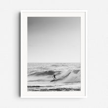 Load image into Gallery viewer, Silhouette of a surfer in the North Sea, framed in white wood, perfect for adding a touch of Scheveningen to your decor. Photographed by Jop Hermans.
