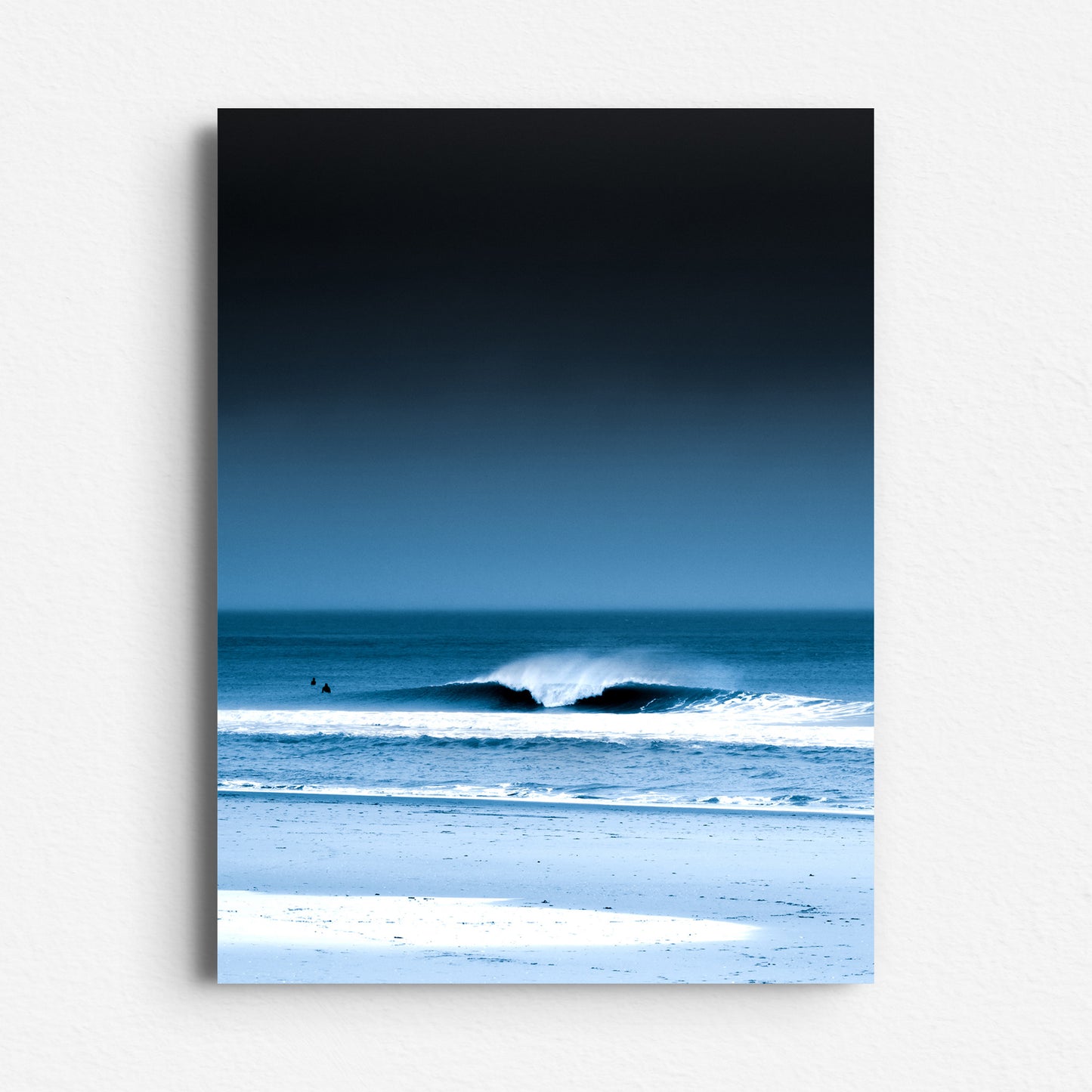 A serene North Sea wave with deep blue tones and moody skies. Printed on Dibond as contemporary wall decoration. Photo art from The Hague.