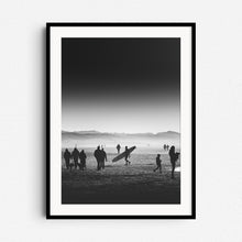 Load image into Gallery viewer, Black and white photo of a man with a longboard on a crowded Dutch beach, framed in black wood, ideal for Surf Photography Netherlands fans.
