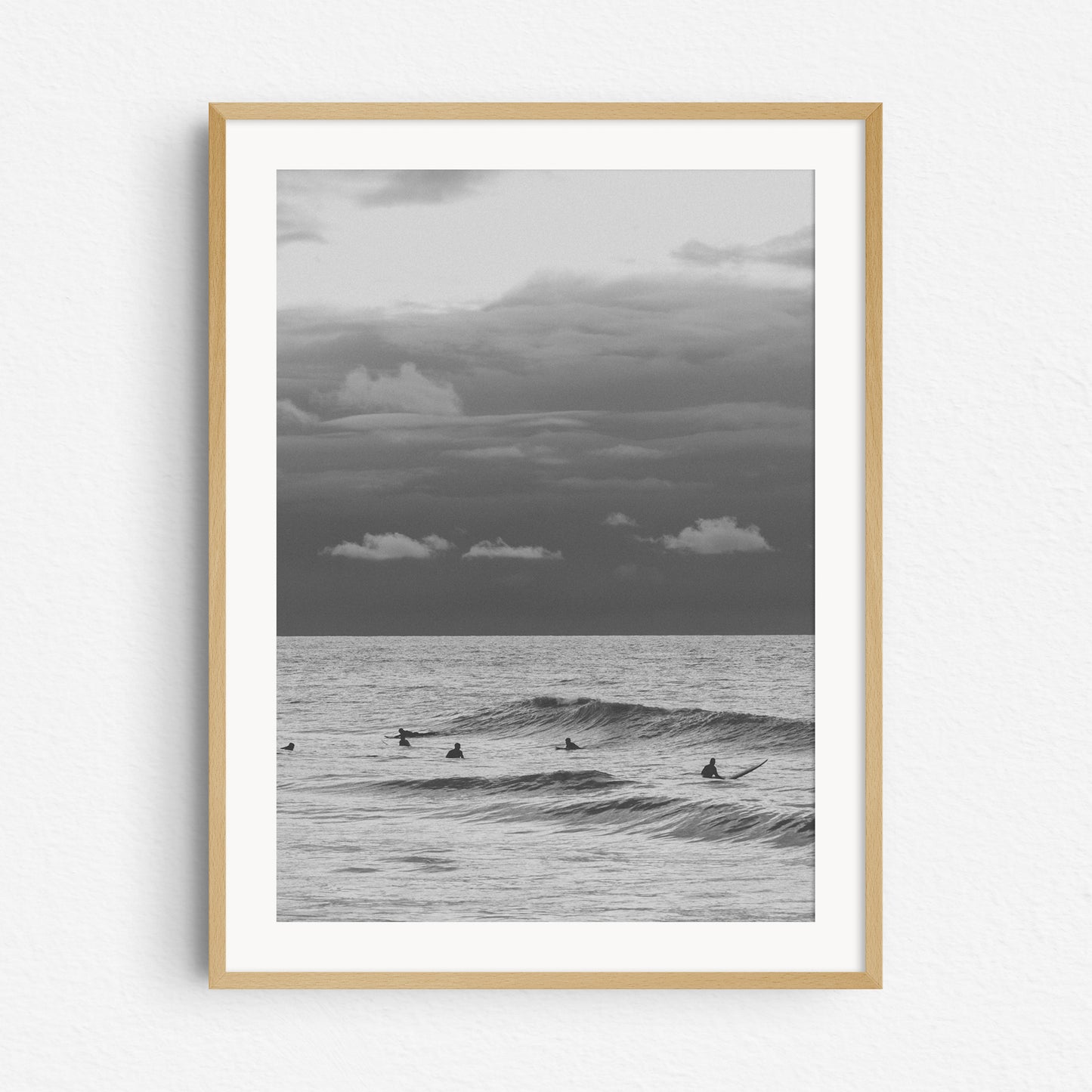 Black and white surf photo in a natural wooden frame.