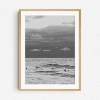 Black and white surf photo in a natural wooden frame.