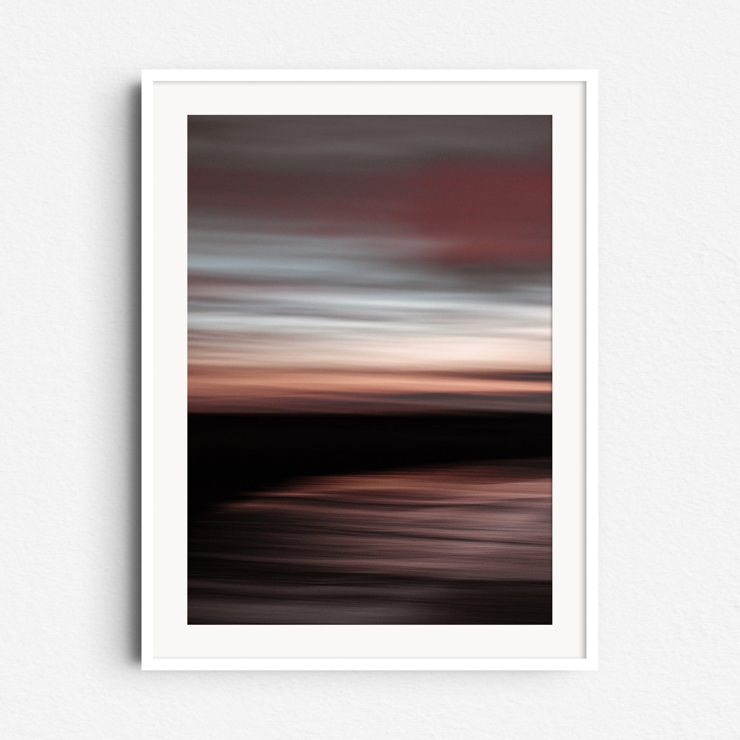 "'Dawn' North Sea sunset photo with soft red and blue tones. Framed in a modern white wooden frame."