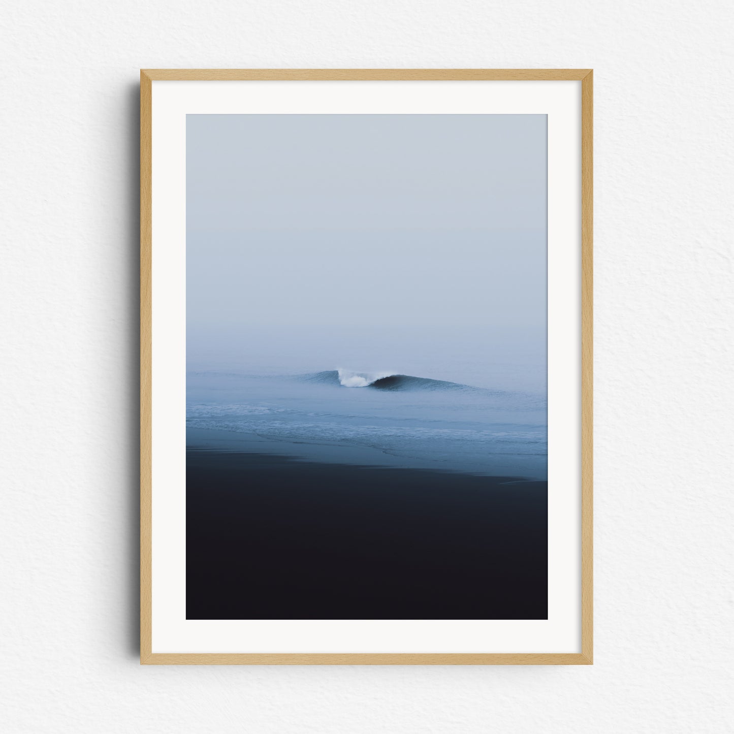 A clean, curling wave on a moody day in Scheveningen. Ocean artwork framed in natural wood for an organic, coastal vibe.