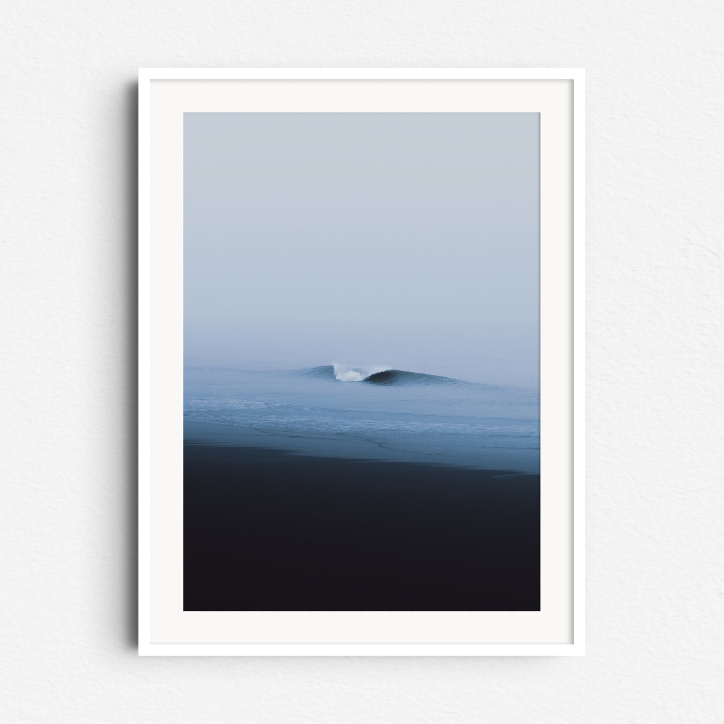 A serene North Sea wave captured on a windless misty day. Framed in white wood. Minimalistic surf photography.