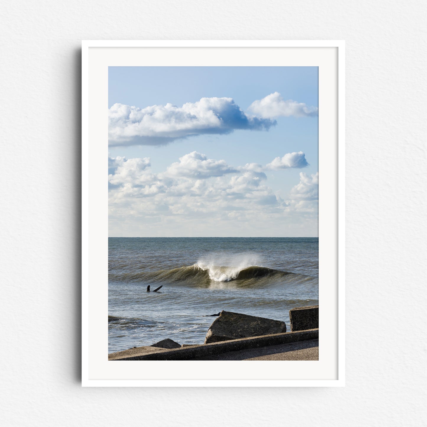 Dutch surf scene under classic skies, framed in white wood to emphasize the fresh, clear atmosphere of the photo. Captured by Jop Hermans.