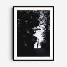 Afbeelding in Gallery-weergave laden, Black and white silhouette of a female surfer holding a longboard in a forest in The Hague, framed in black wood, ideal for Dutch photo art enthusiasts.
