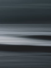 Load image into Gallery viewer, Abstract ocean view with two waves visible in a motion blur. A long exposure photographs with a dark mood.
