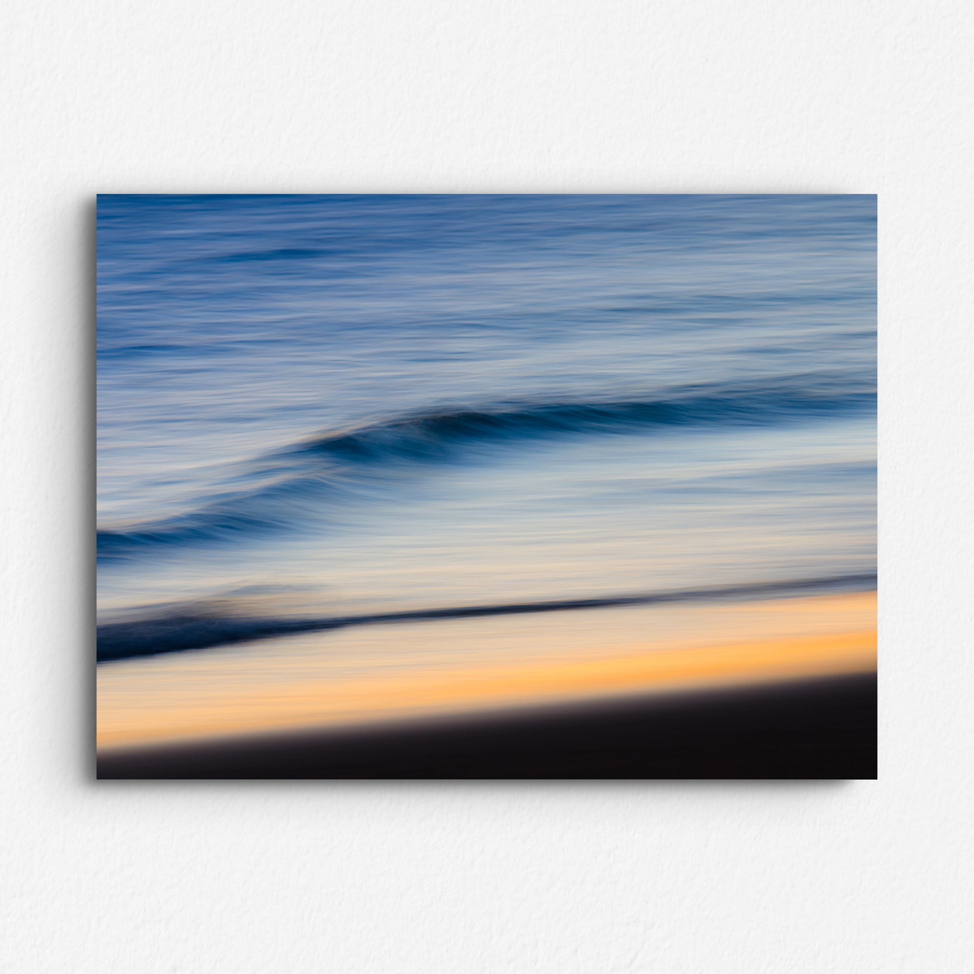 Long exposure photo of the North Sea water surface, with a blue and orange haze. Printed on Dibond for a modern finish.