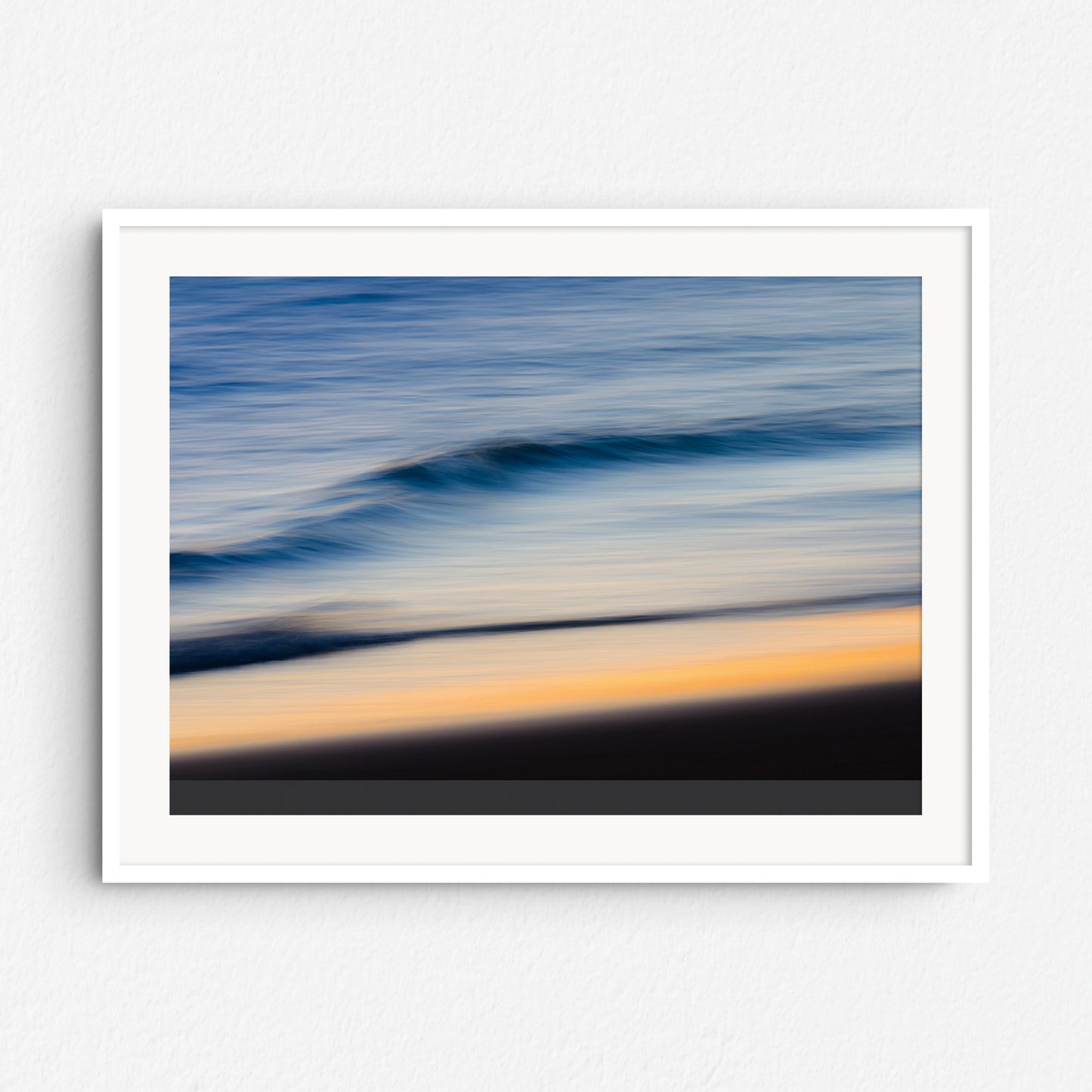 Beautiful sunset colors on the North Sea, framed in white wood to highlight the soft movement and vibrant hues.