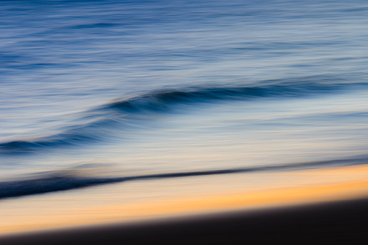 Moving water on the dutch shoreline photographed with a long shutter speed, giving it a cloudy effect.