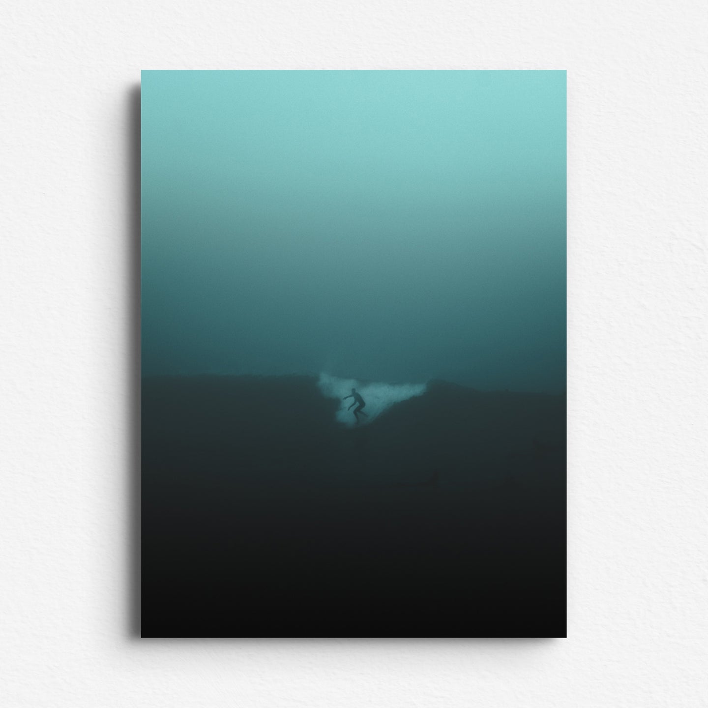 Turquoise-toned surf scene with a silhouetted surfer in mist, printed on Dibond for a sleek, modern finish. The Hague sea and surf art.