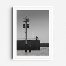 Load image into Gallery viewer, Silhouette of a surfer in Scheveningen, captured in black and white, framed in white wood to enhance its minimalistic beauty. Sea and surf wall art from The Netherlands.
