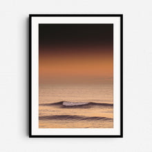 Load image into Gallery viewer, Golden wave breaking at sunset with a dark mood, framed in black wood. A captivating piece for modern interiors.
