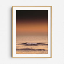 Load image into Gallery viewer, Smooth golden wave breaking under the sunset, framed in natural wood. Perfect as coastal-inspired room decor.
