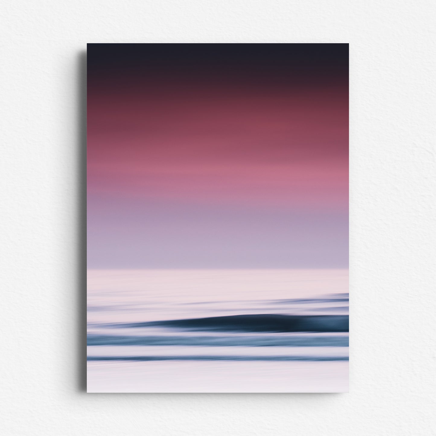 A vivid abstract photo of purple sunset sky and dreamy waves. Poster printed on Dibond for modern wall art with coastal charm.