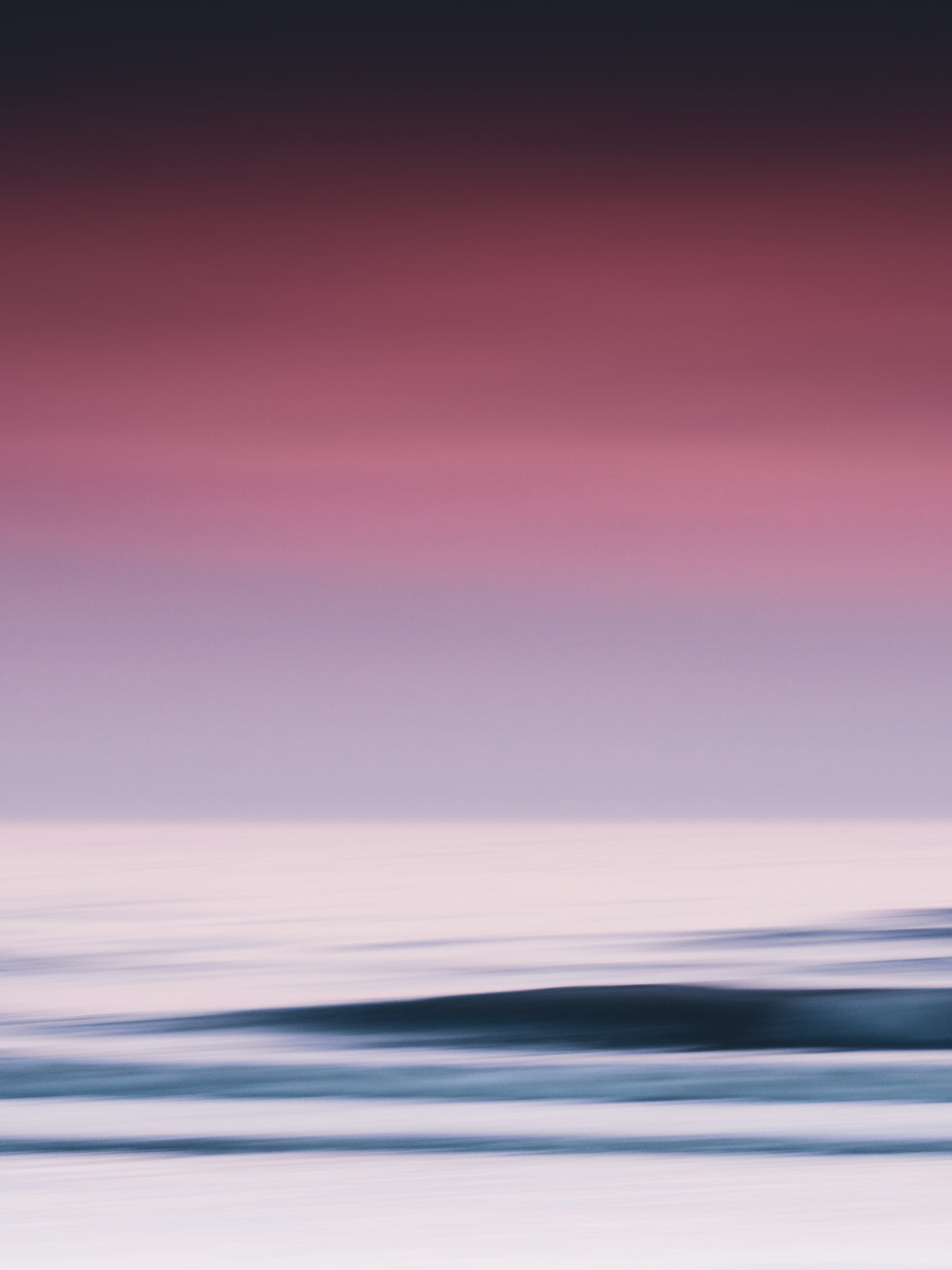 A serene abstract sea photo in purple hues, captured in The Hague. Long exposure creates soft, dreamy waves for a calming artistic piece.