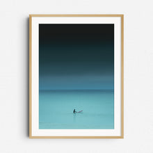 Load image into Gallery viewer, Moody turquoise nature photography of a surfer in the North Sea waiting for a wave. Framed in natural wood, ideal for nature and surf photography lovers. Captured by Jop Hermans
