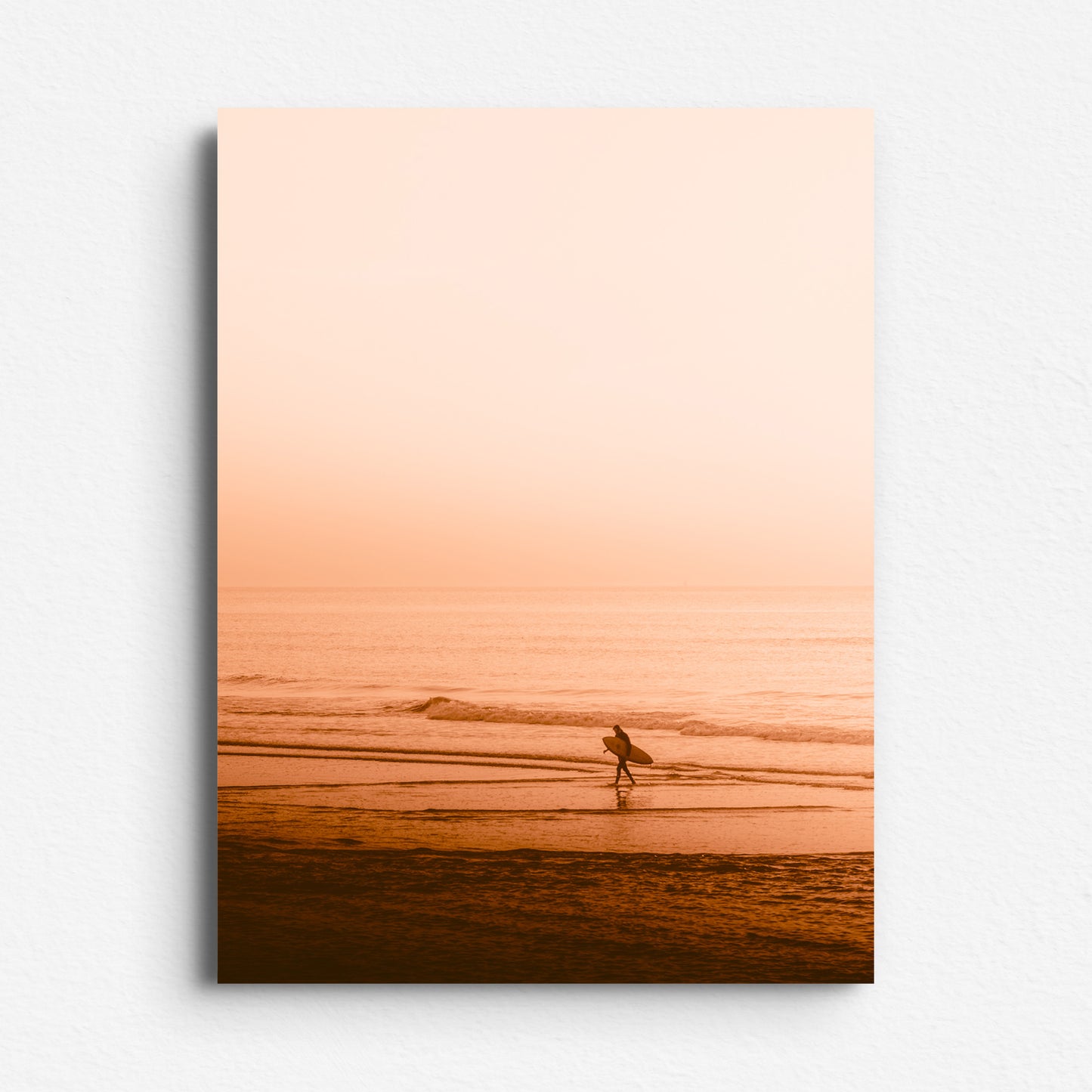 Surfer walking the Scheveningen beach in a bright orange sunset. The Hague photo art printed on aluminium dibond.