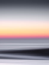 Load image into Gallery viewer, Motion blur from a north sea wave during an orange sunset. The photograph has a dark mood.
