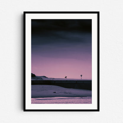 Scheveningen harbor with a surfer, captured from the north side, framed in black wood to enhance the familiar coastal angle.