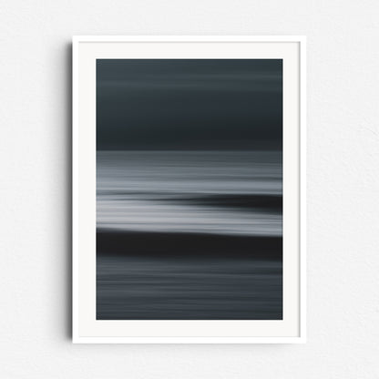 "Shades" – artistic North Sea seascape with striking light-dark tones. Framed in white wood for sleek, modern wall art.